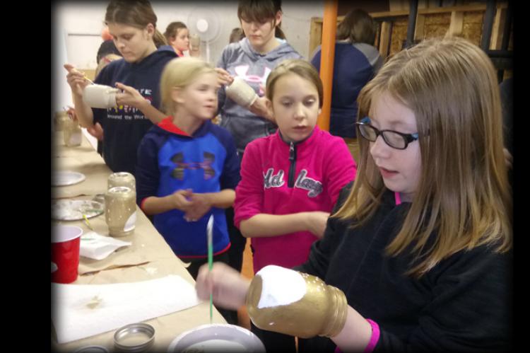 kids painting their candle jars